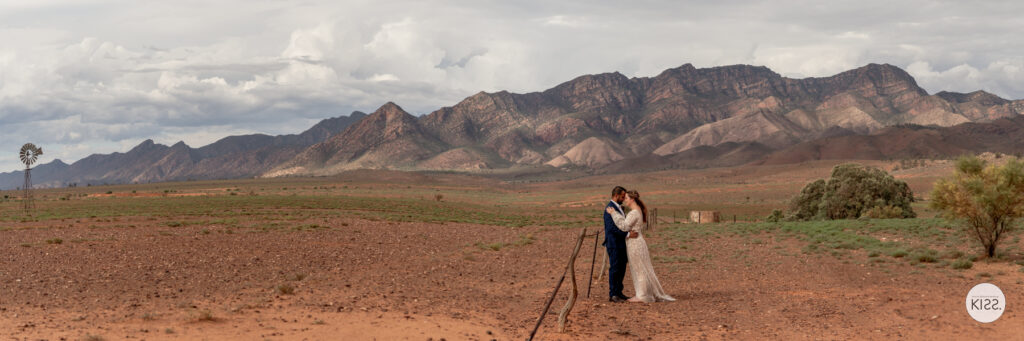 A wedding couple in an open landscape beneath the Flinders Ranges