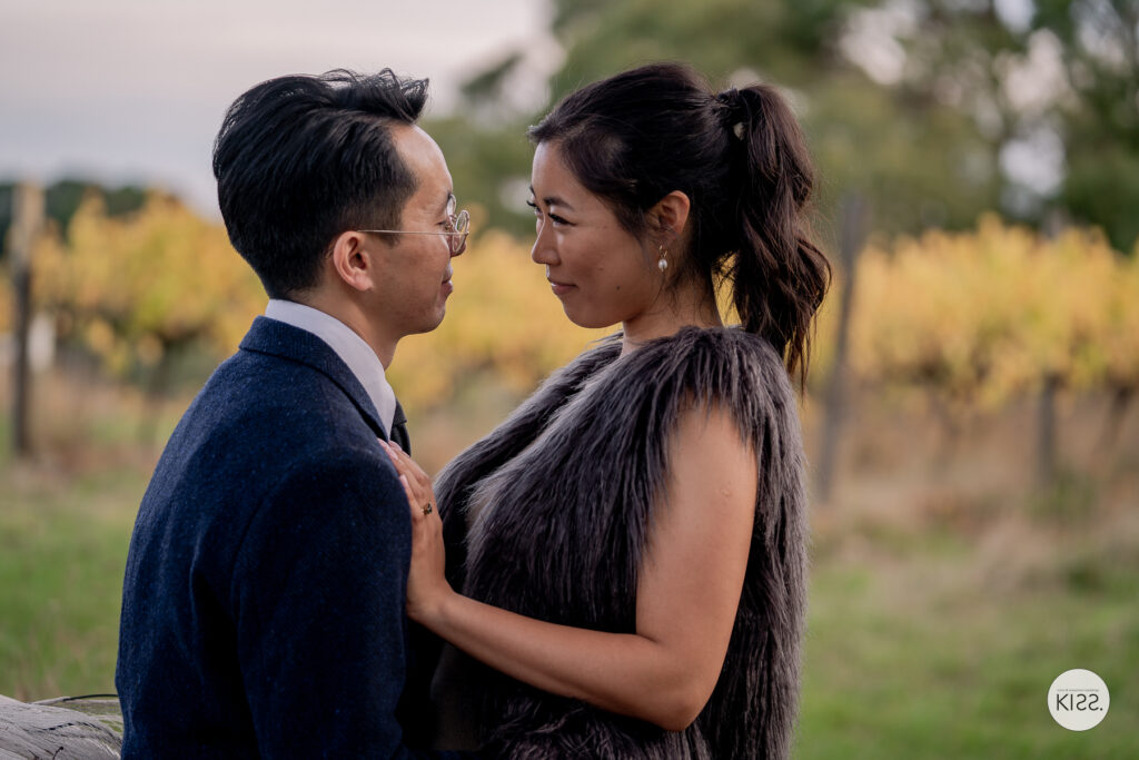 A couple smiling together during an outdoor engagement session