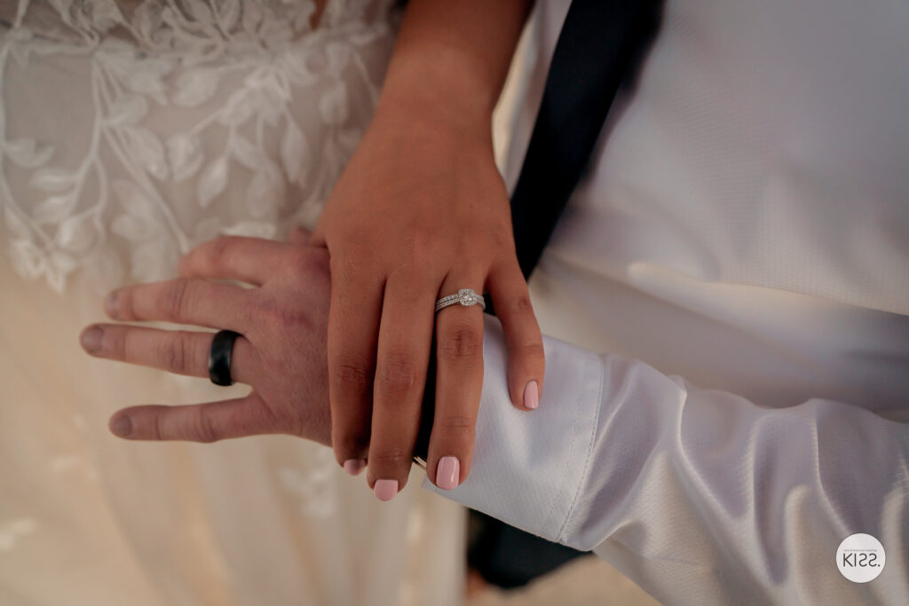Close-up of a couple's hands and wedding rings