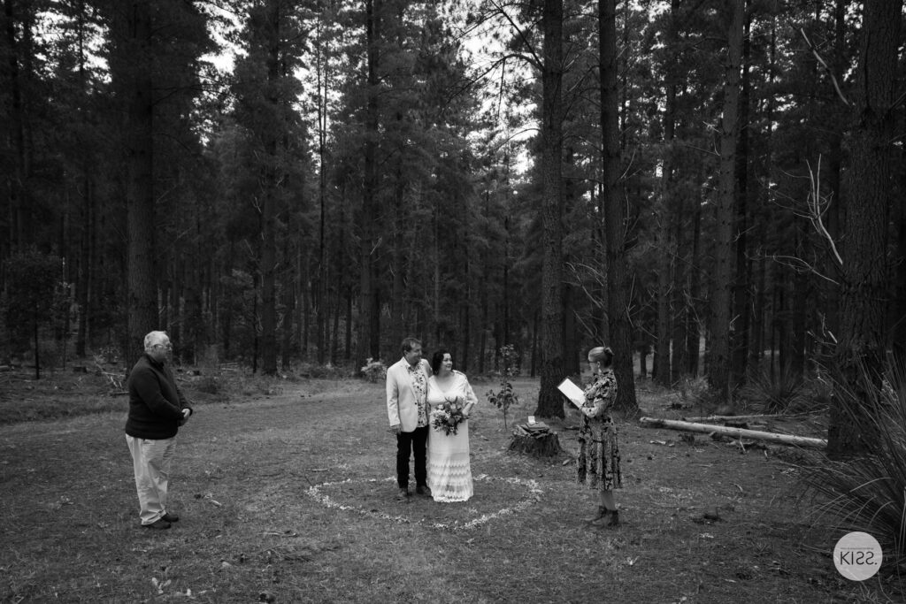 A small forest wedding ceremony in black and white