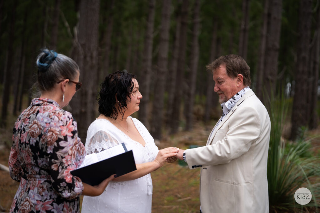 A celebrant guiding a couple through their ring exchange
