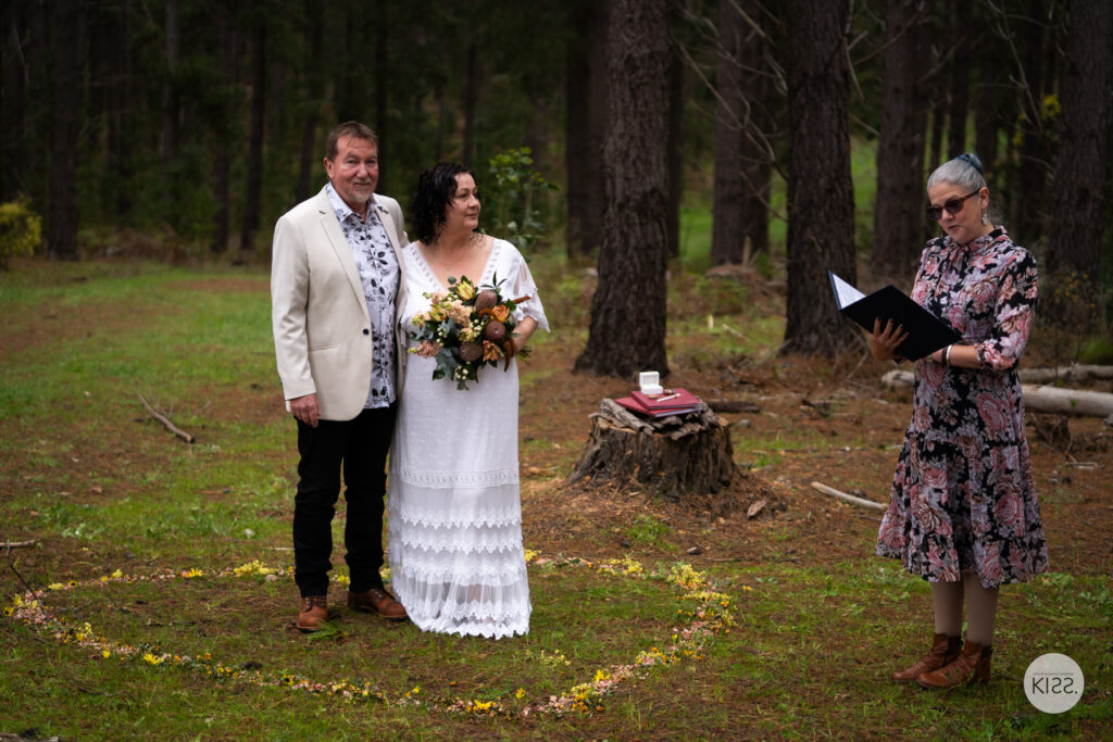 Deb standing with a newly married couple