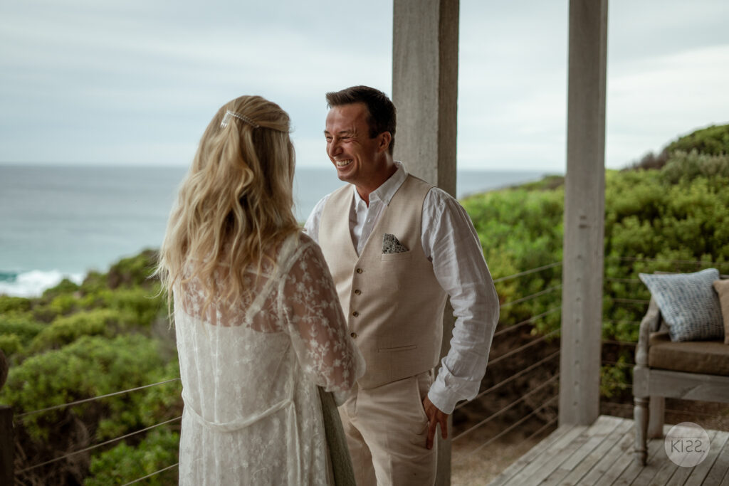 A couple smiling together during their ocean-view ceremony