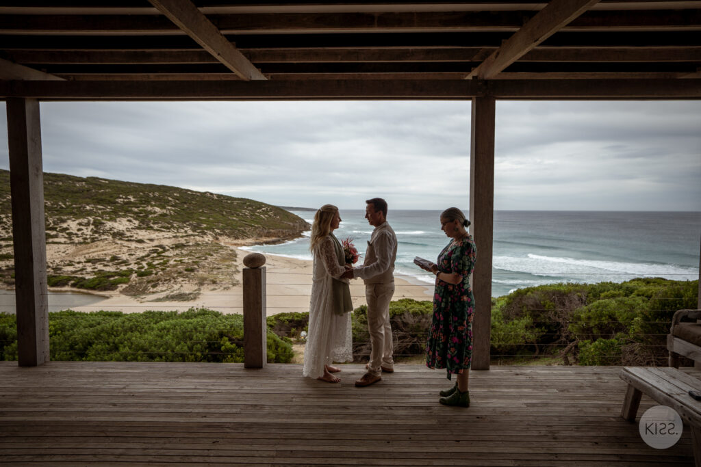 A small wedding ceremony overlooking a sandy cove
