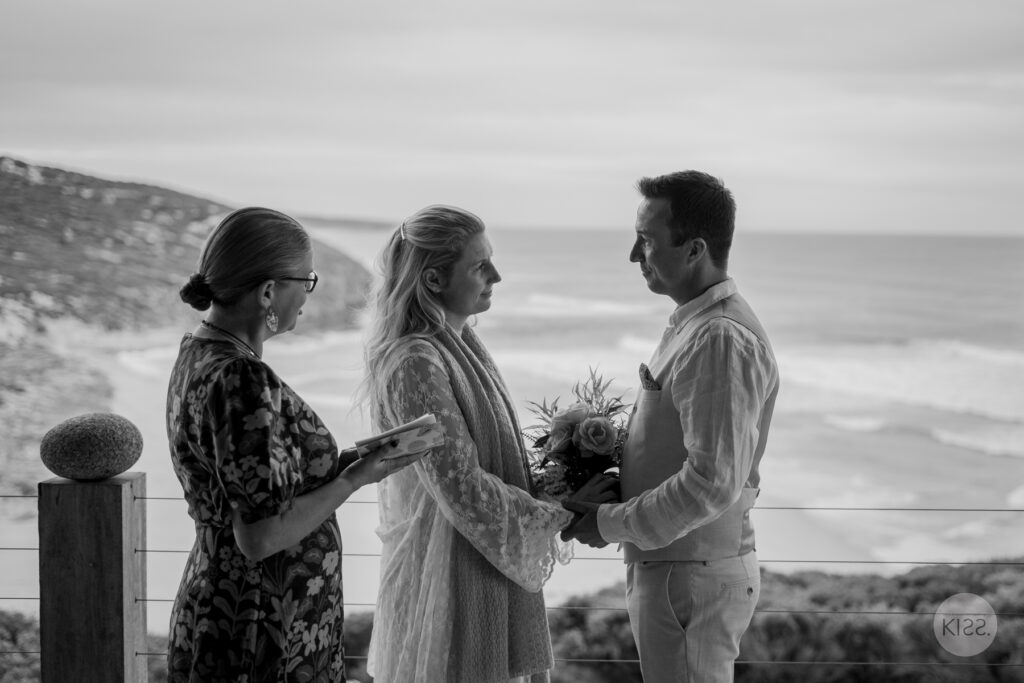 A couple and celebrant on a Kangaroo Island deck in black and white
