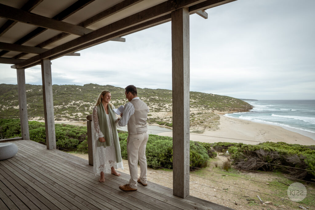 A wedding couple standing on the deck at Wild Side Ocean Retreat