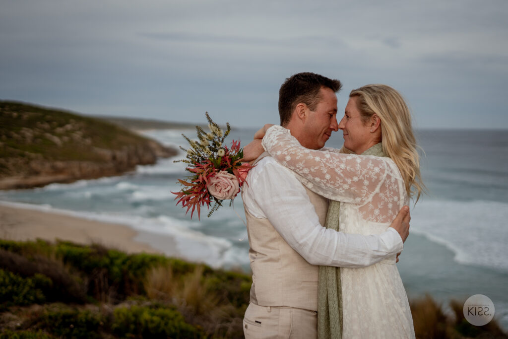 A wedding couple embracing above a Kangaroo Island beach