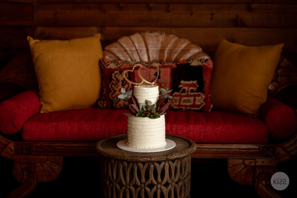 Small white wedding cake decorated with flowers