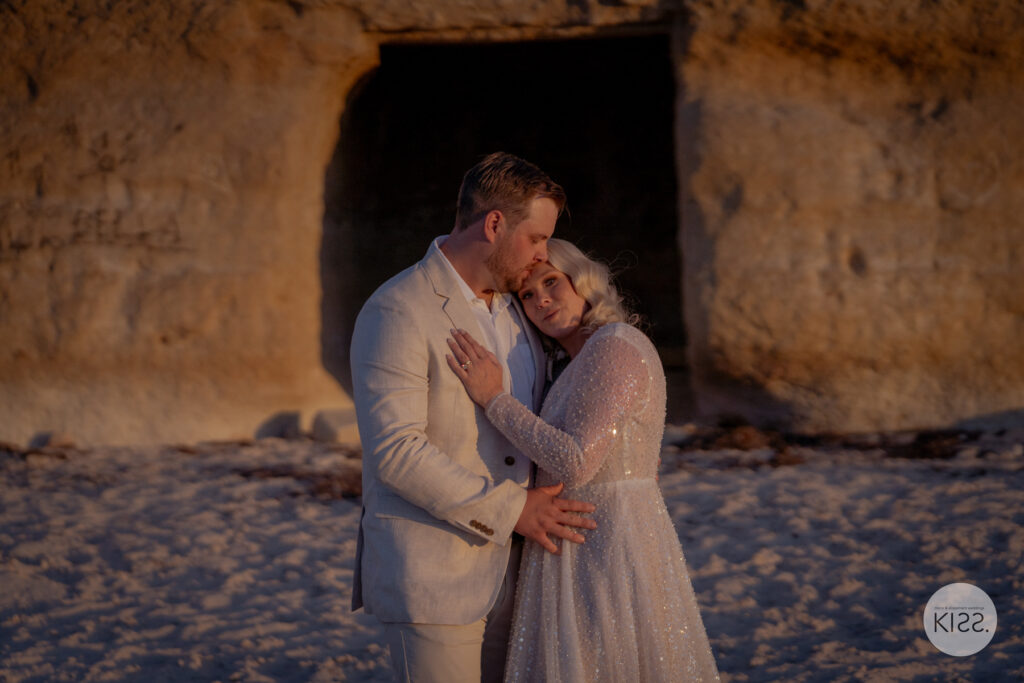 A couple embracing beside a coastal cave at Port Willunga