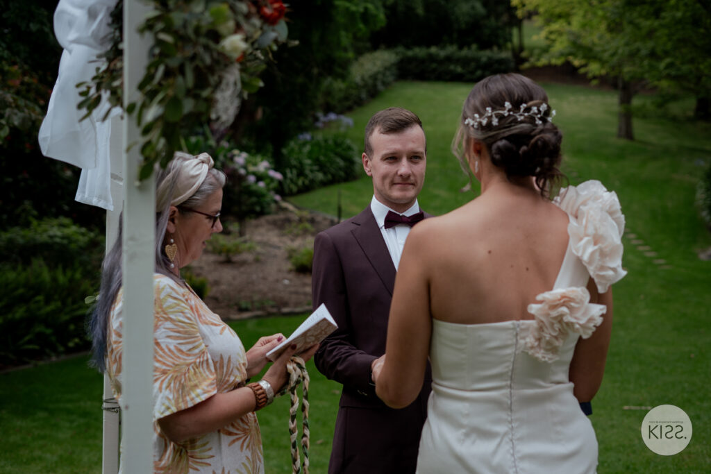 A groom smiling during his wedding ceremony