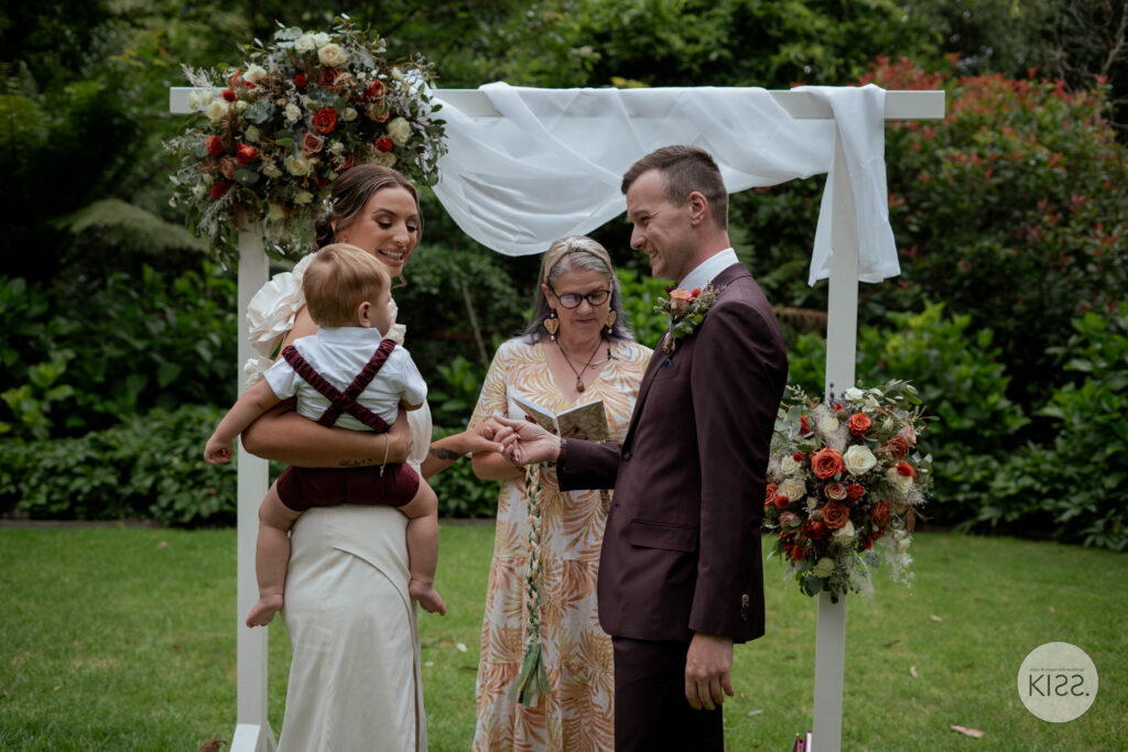 A celebrant speaking during a small garden wedding