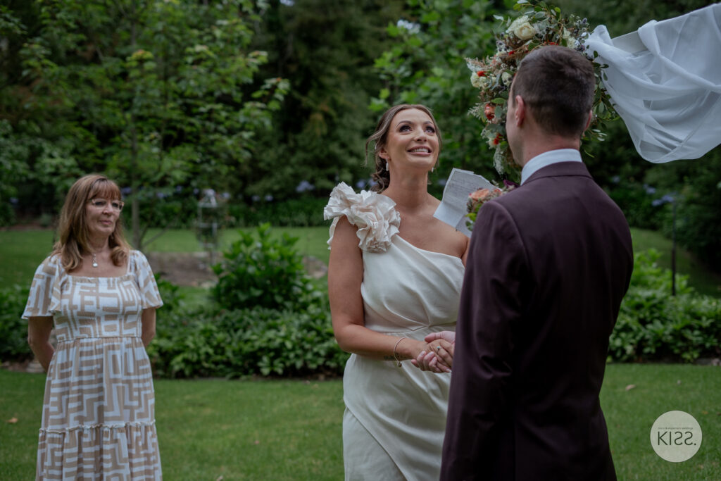 A bride laughing during her garden wedding ceremony