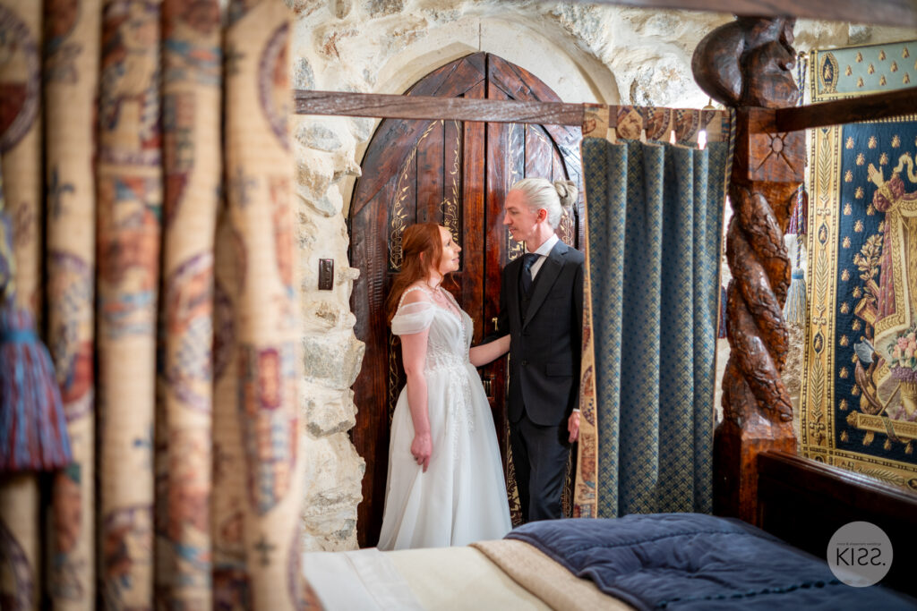 A wedding couple standing together in an ornate room at Thorngrove Manor