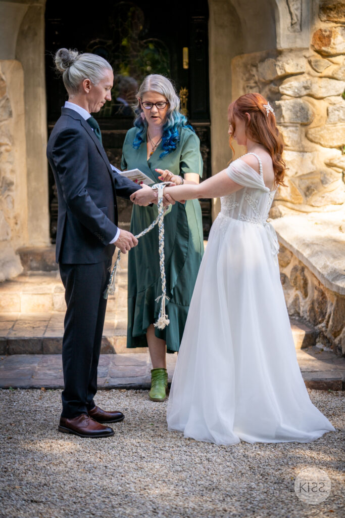 A couple exchanging vows with their celebrant at Thorngrove Manor