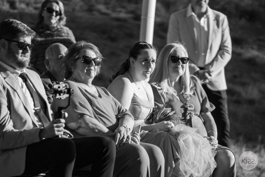 Seated wedding guests in black and white