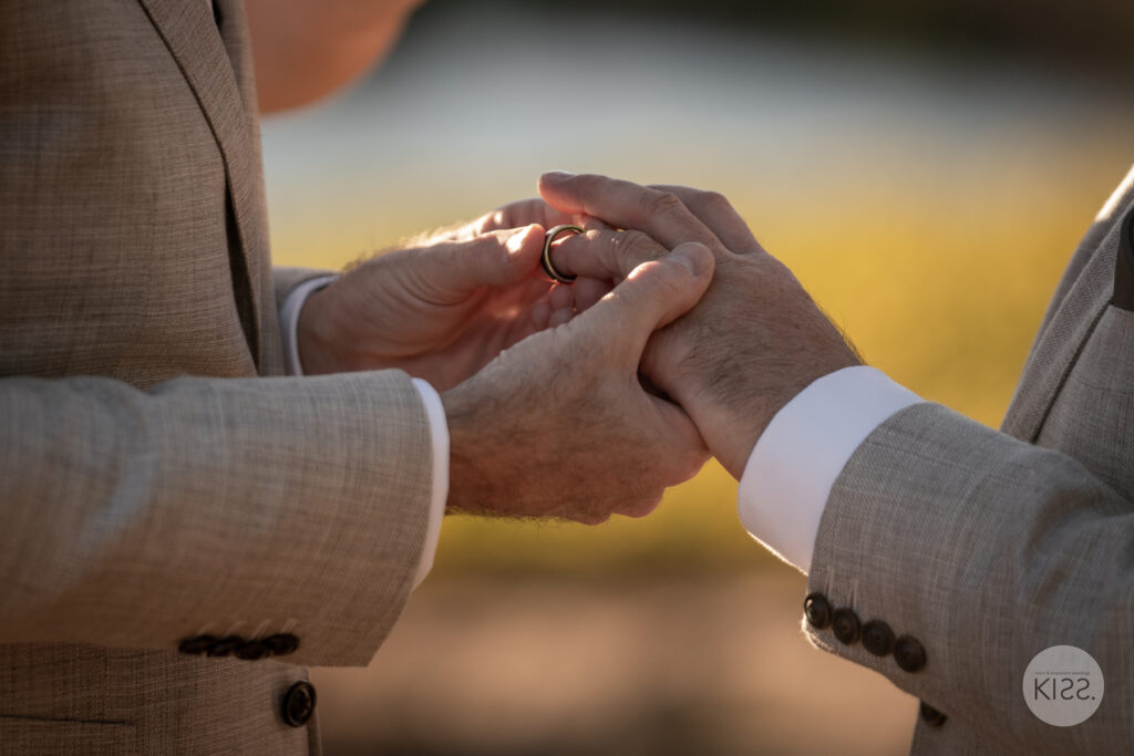 Close-up of hands during a wedding ring exchange