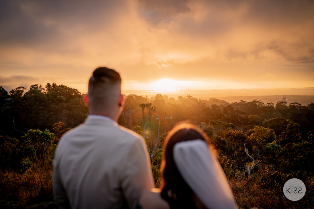 A wedding couple looking out towards the sunset