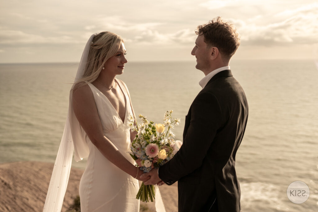 A couple exchanging vows on the coast at Port Willunga