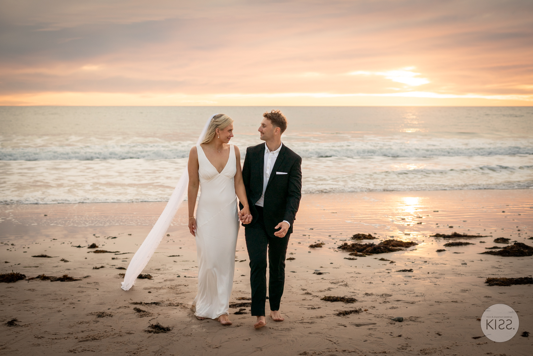 Couple walking on empty beach