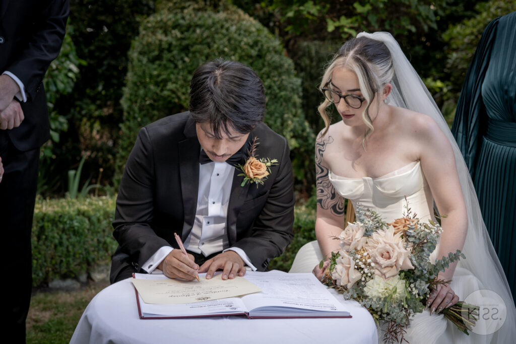 A couple signing their marriage register