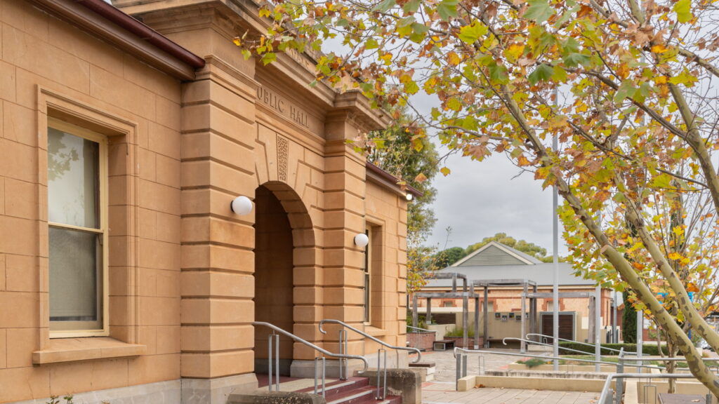 Exterior of McLaren Vale Institute Hall beside an autumn tree