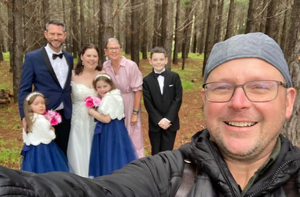 The KISS team with a wedding couple and family in a forest