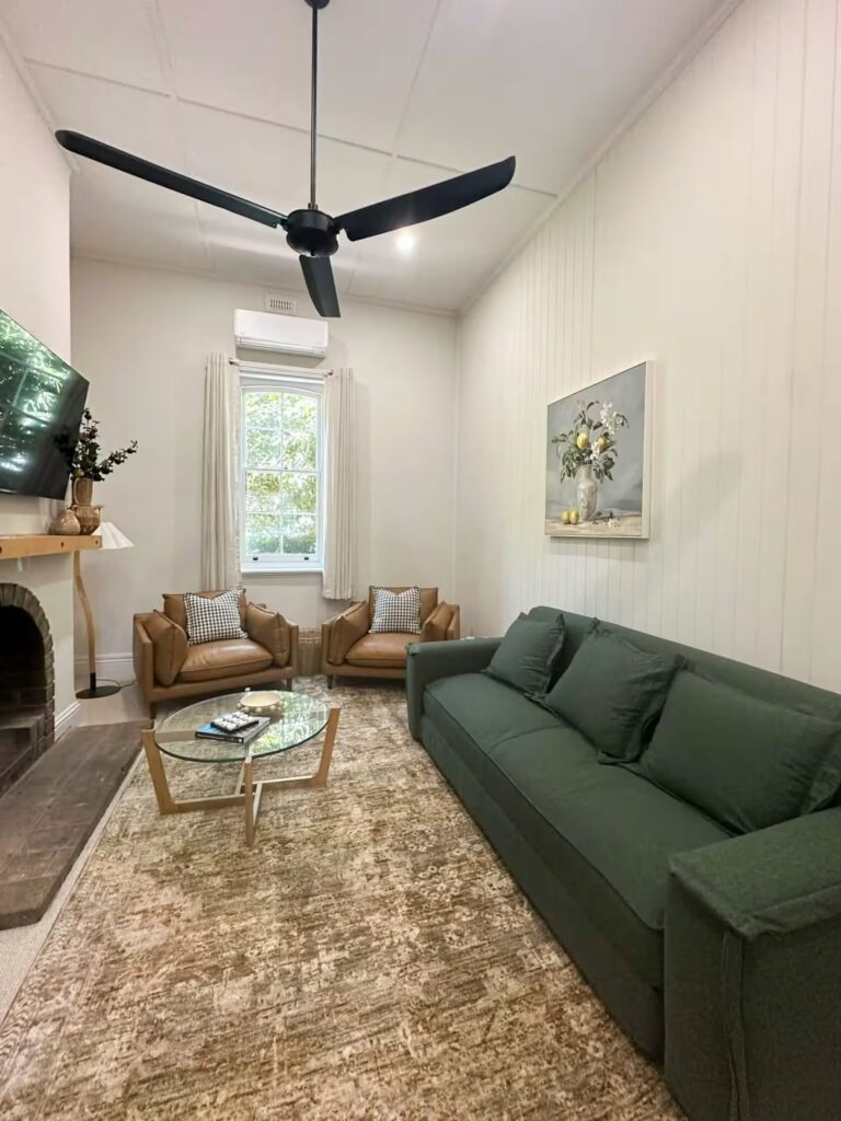 Cottage living room with a green sofa and fireplace