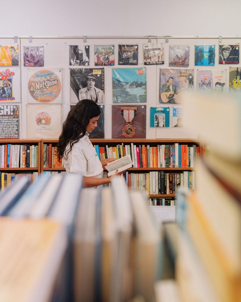 Visitor browsing books at The Strand Books & Records in Port Elliot.