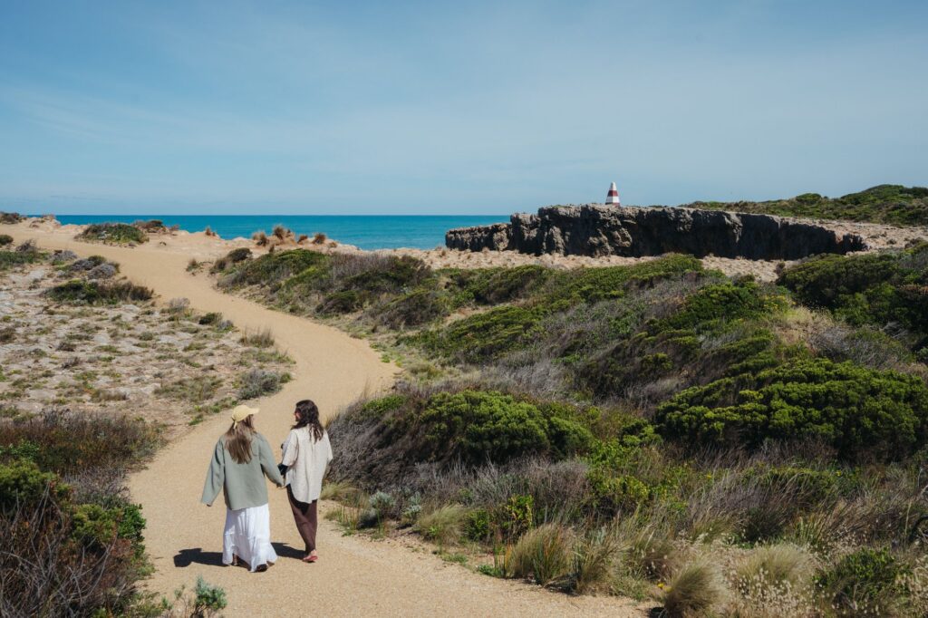 Couple on the coastal path with the Robe Obelisk in the distance.