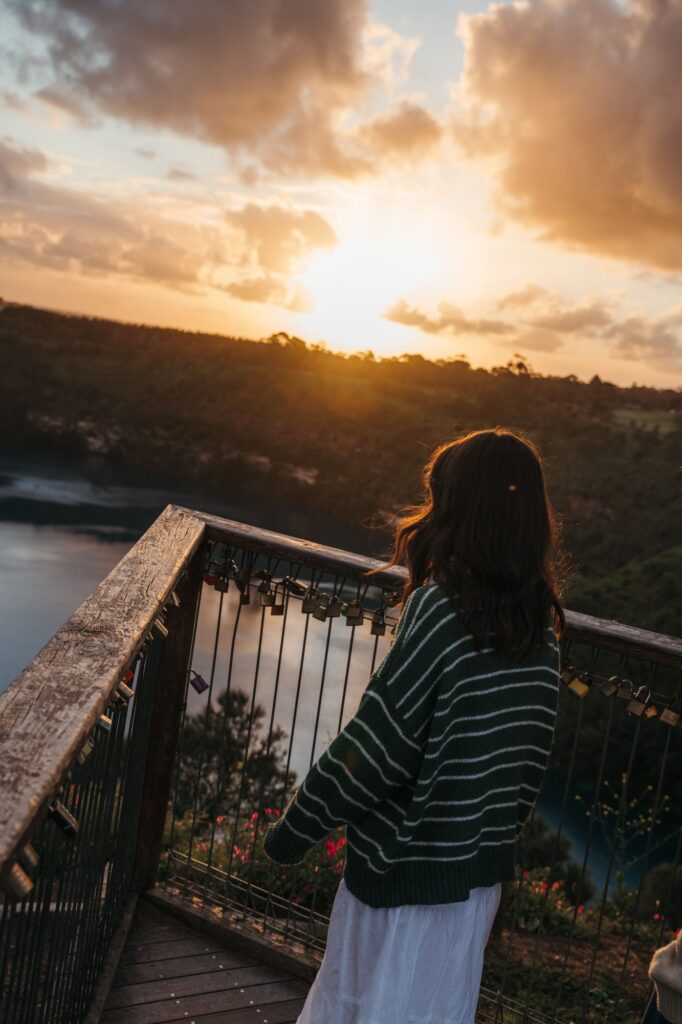 Visitor at the Blue Lake/Warwar lookout in Mount Gambier at sunset.