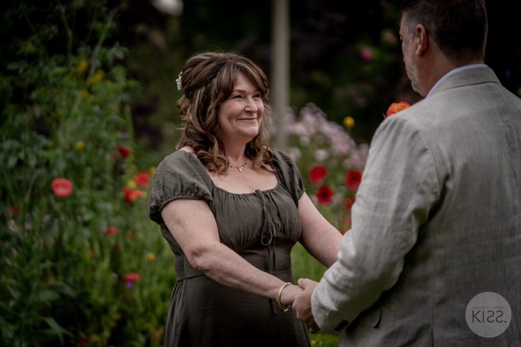 A couple smiling together in a garden setting