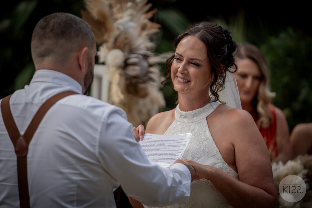 A couple smiling during their vows at Adelaide Botanic Garden