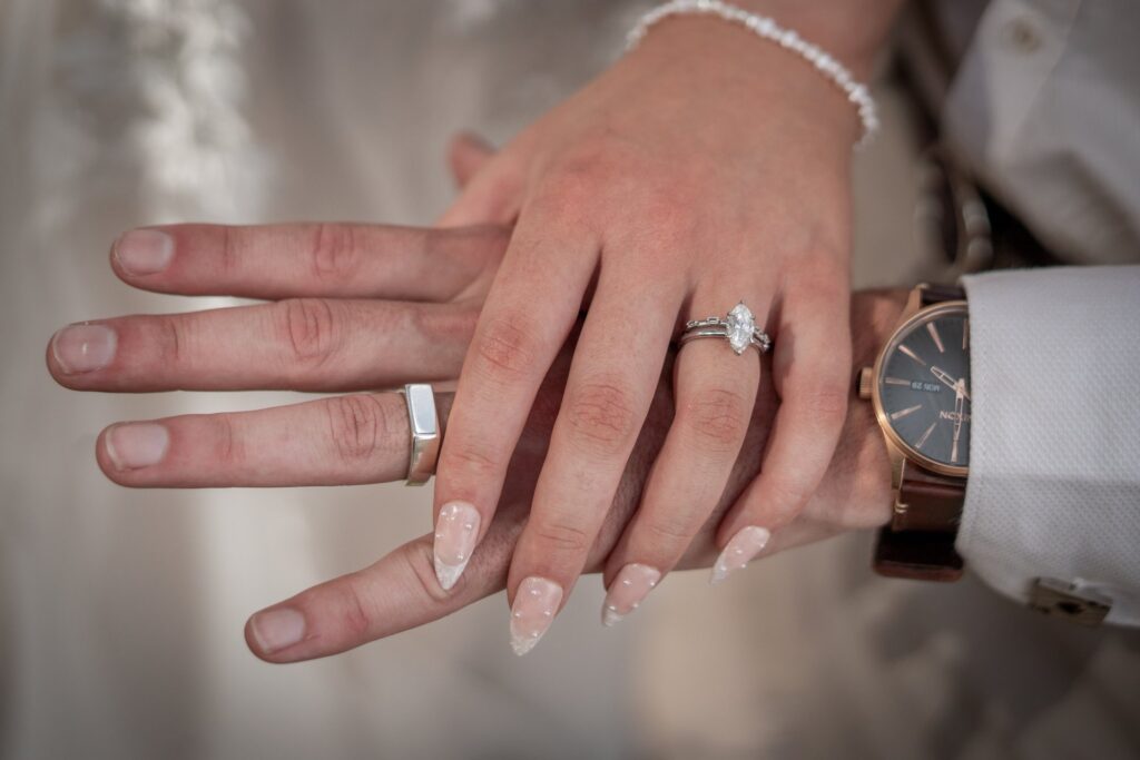 A couple showing their wedding rings after a Carrickalinga wedding