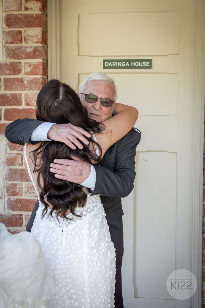 A warm embrace at a doorway on a wedding day